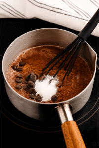 Add the chocolate: Using hot cocoa mix: whisk directly into the warm milk until dissolved.Using chocolate chips + cocoa powder + sugar: add them now and whisk until melted and glossy.