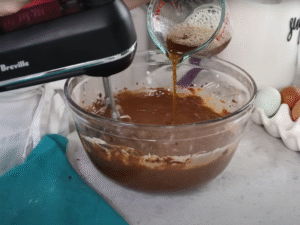 Gradually add the buttermilk, mixing until fully incorporated. Then slowly pour in the hot coffee, stirring until the batter is glossy and uniform.