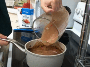 Pour the blended mixture back into the saucepan with the remaining hot chocolate. Stir well to combine and warm through.