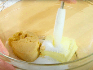 Cream the base – In a large bowl, beat the softened butter with both sugars until light and fluffy. Mix in the egg and vanilla until smooth.