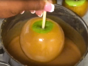 Coat each chilled apple slice in caramel, letting excess drip off. Place on parchment to set.