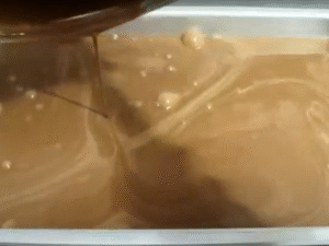 Pour into a shallow metal baking dish (about 40×25 cm) and place in the freezer until partially set.