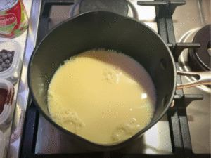 In a saucepan, combine the milk and cream. Warm gently over medium heat.