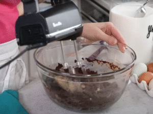 Add the eggs, extra yolk, and vanilla extract. Mix until smooth, scraping down the sides and bottom of the bowl as needed.