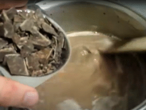 Remove from heat and stir in the chopped dark chocolate until fully melted.