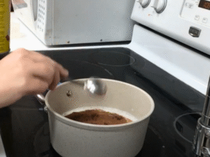 Add the cocoa powder, brown sugar, salt, and chopped chocolate. Stir continuously until the mixture is smooth and the chocolate has melted.