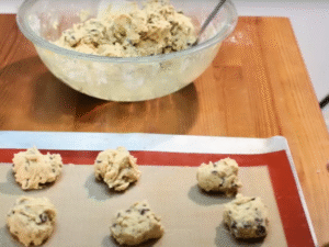Drop rounded spoonfuls of dough (about 2 tbsp each) onto the baking sheet, leaving space between. Bake 10–12 minutes until edges are golden but centers look slightly soft.