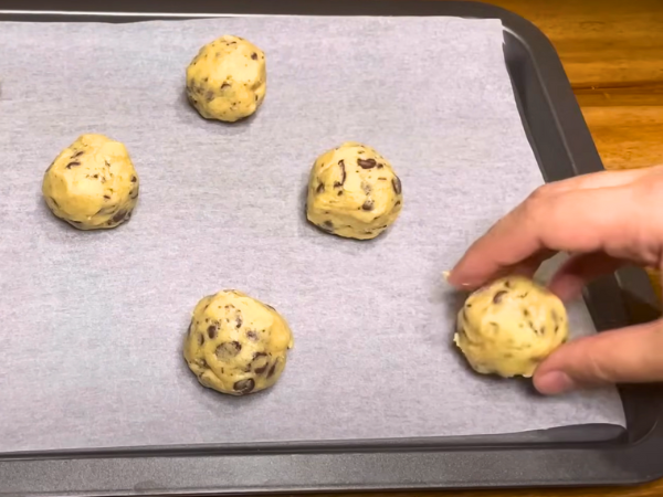 Shape Cookies – Drop spoonfuls of dough onto a greased or parchment‑lined baking sheet.