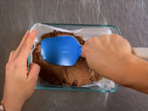 Press the mixture firmly into a small lined container, smoothing the top with a spatula.