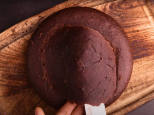 Cut the cooled cake into even layers. Place the first layer on a plate, spread ganache, then repeat with remaining layers.