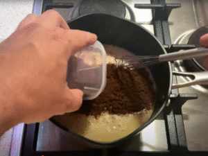 Add sugar, egg yolks, and cocoa powder. Stir continuously until smooth.