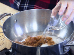 Pour in the hot water and whisk over medium heat until the mixture forms a smooth chocolate base.