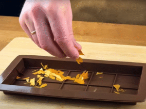 Lightly dust a silicone mold with edible gold glitter to create a shimmering base.