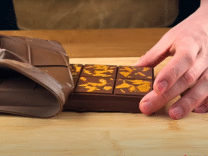 Once firm, carefully release the chocolate from the mold and admire your golden, layered masterpiece.